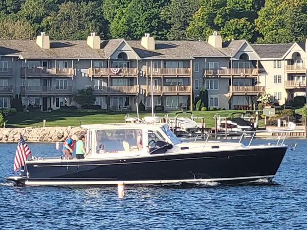 MJM 36z Downeast 2013 MJM 36z Downeast boat cruising on a lake with waterfront condos in the background.