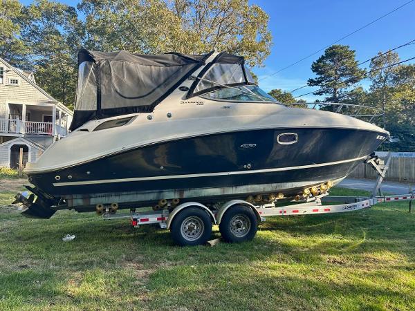 Sea Ray 280 Sundancer 2013 Sea Ray 280 Sundancer boat on trailer, parked on grass.