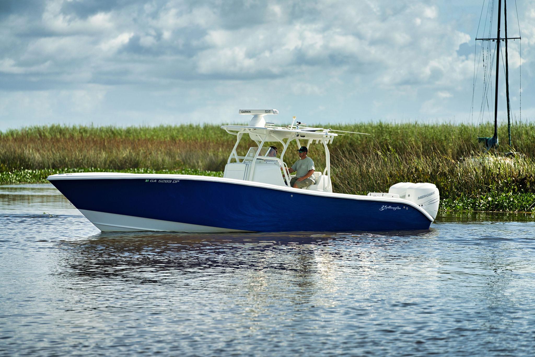 Yellowfin 32 Offshore 2017 Yellowfin 32 Offshore boat cruising on calm water, with grassy shoreline in background.