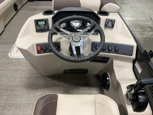 Bennington 23 SL 2025 Bennington 23 SL boat dashboard with steering wheel and controls.