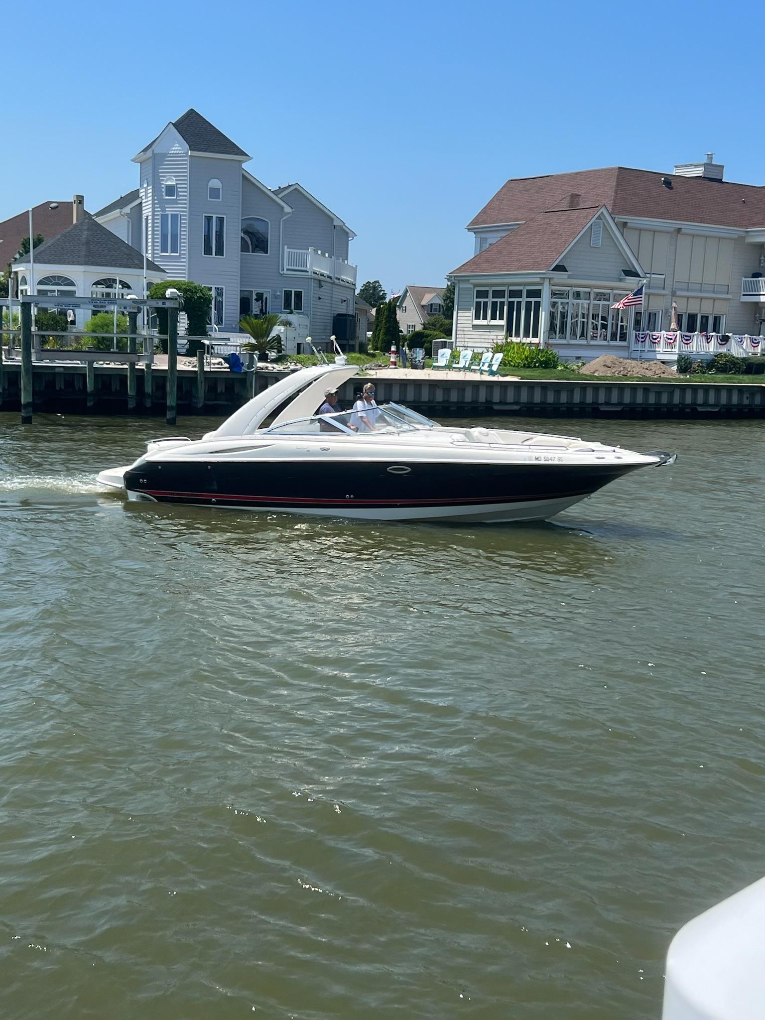 Monterey SS29 Monterey SS29 boat cruising near waterfront homes, 2004 model.