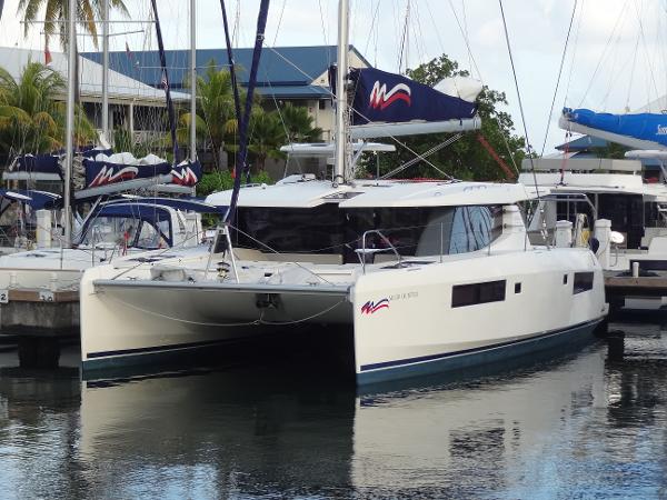 Leopard 45 2020 Leopard 45 catamaran docked in marina, featuring sleek design and modern sails.