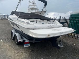 Larson 206 sensa 2008 Larson 206 Sensa boat on trailer, covered and parked near a marina.