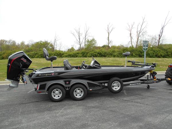 Ranger Z520R 2023 Ranger Z520R bass boat with dual axle trailer in parking lot.