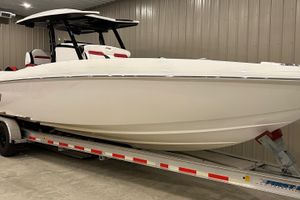 Sunsation 32 CCX 2023 Sunsation 32 CCX boat on trailer in indoor storage facility.