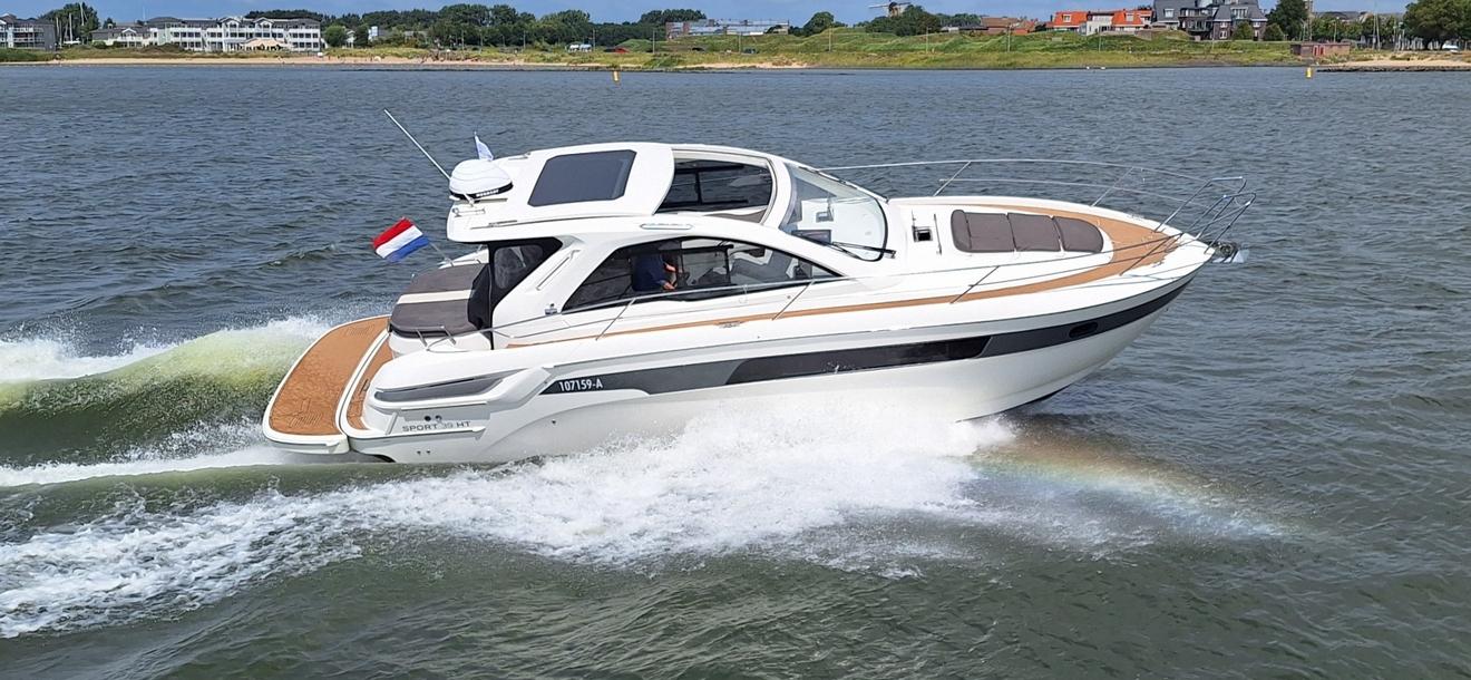Bavaria 39HT 2012 Bavaria 39HT yacht cruising on a scenic waterway with shoreline in the background.
