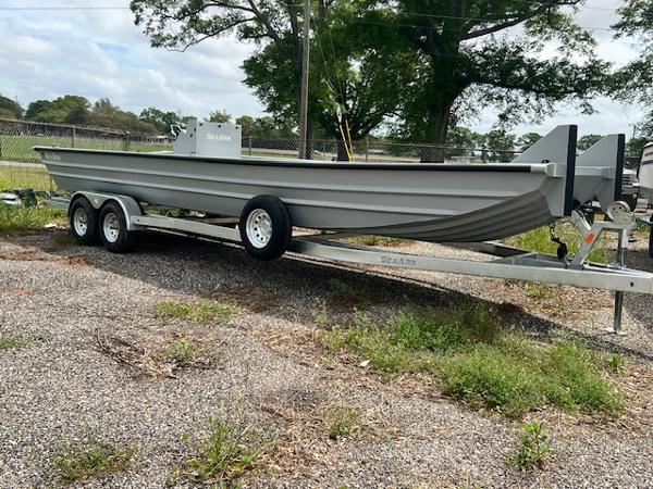 SeaArk 2672 Workhorse 2025 SeaArk 2672 Workhorse boat on trailer, parked outdoors.