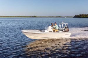 Hewes 16 Redfisher 2025 Hewes 16 Redfisher boat cruising on a calm lake with two passengers.