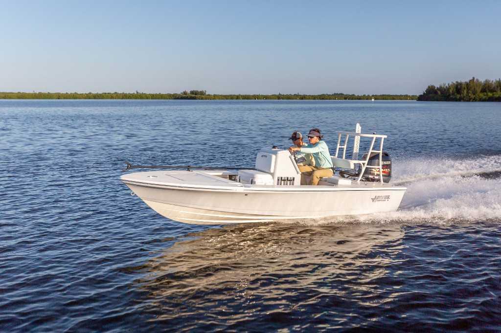 Hewes 16 Redfisher 2025 Hewes 16 Redfisher boat cruising on a calm lake with two passengers.