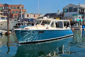 MJM 35 2023 MJM 35 boat docked in a marina with waterfront buildings.