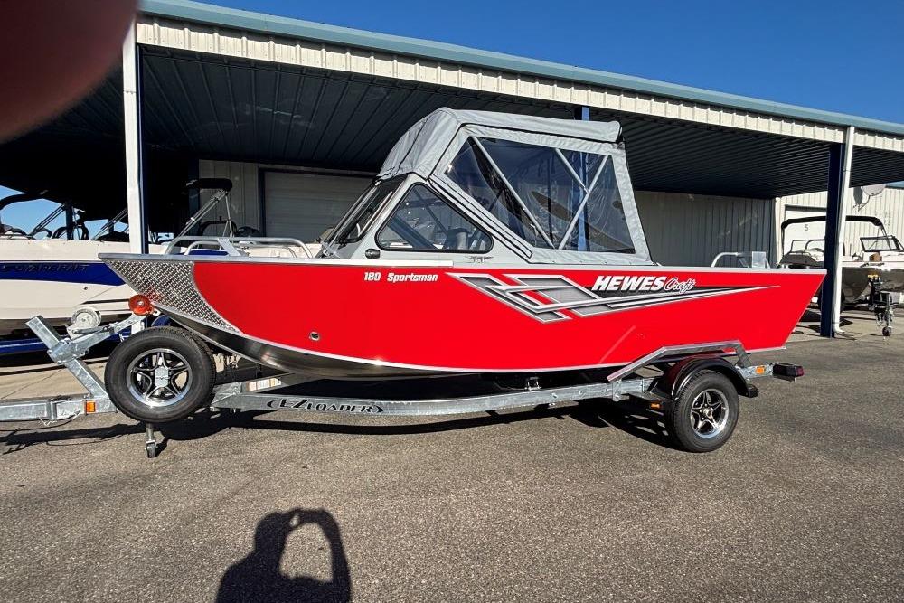 Hewescraft 180 Sportsman 2025 Hewescraft 180 Sportsman boat in vibrant red on a trailer.