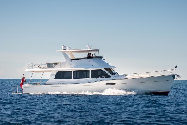 Grand Banks GB 60 2026 Grand Banks GB 60 yacht cruising on open sea under clear sky.