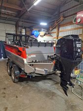 Stabicraft Treker Profish 2024 Stabicraft Treker Profish boat with Tohatsu 150 engine in a garage.