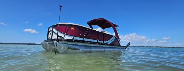 South Bay 500 2017 South Bay 500 pontoon boat on clear water under blue sky.