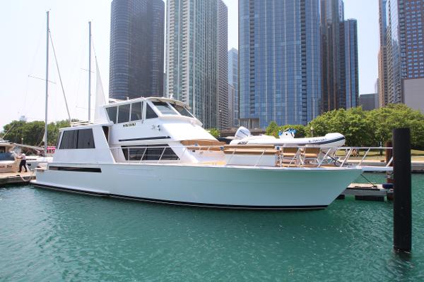 Viking 60 Cockpit Motor Yacht 1997 Viking 60 Cockpit Motor Yacht docked in a city marina with skyscrapers in the background.