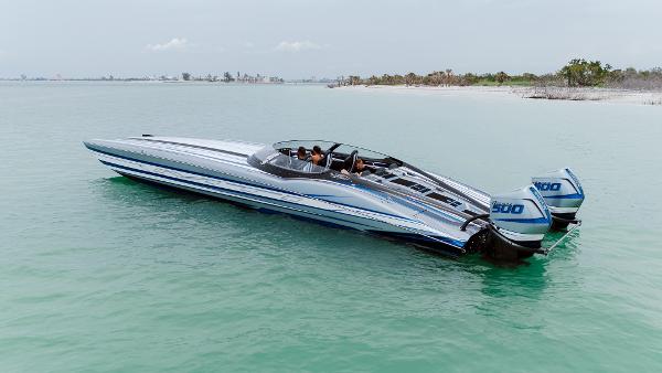 MTI 440X 2024 MTI 440X powerboat with dual engines on calm turquoise water.