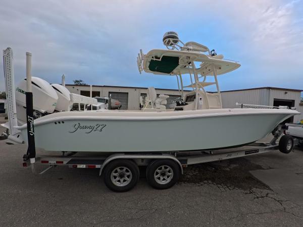 Young Boats 27 2019 Young Boats 27 on trailer, parked outdoors, featuring dual engines and T-top.