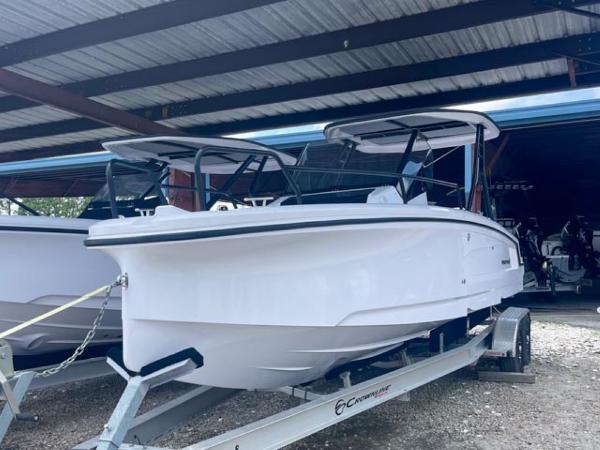 Axopar 25 Cross Top 2024 Axopar 25 Cross Top boat on trailer in covered storage.