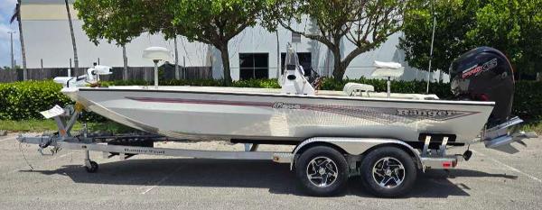 Ranger RB200 2024 Ranger RB200 boat on trailer, parked outdoors, side view.
