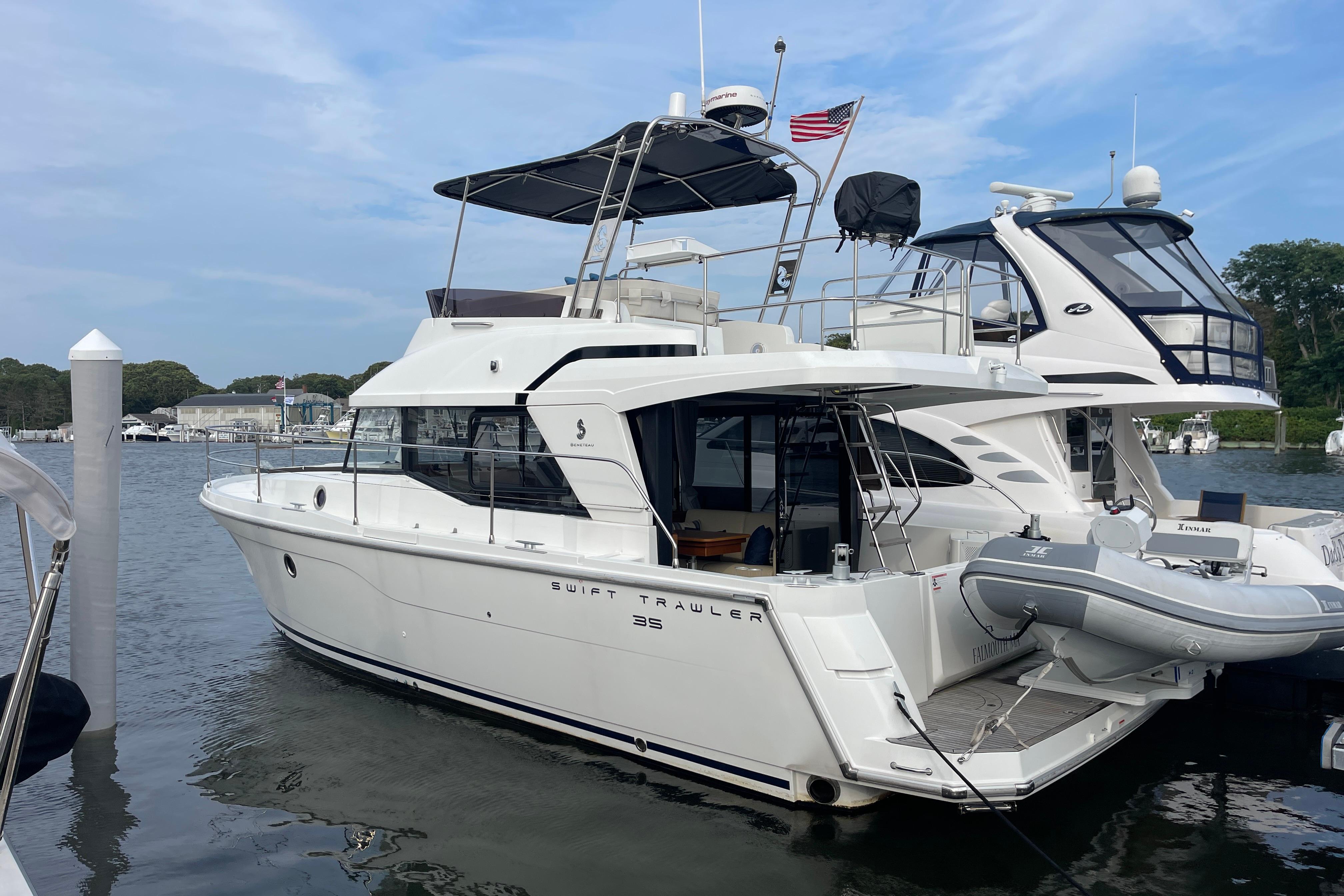 Beneteau Swift Trawler 35 2018 Beneteau Swift Trawler 35 docked at marina, featuring sleek design and spacious deck.