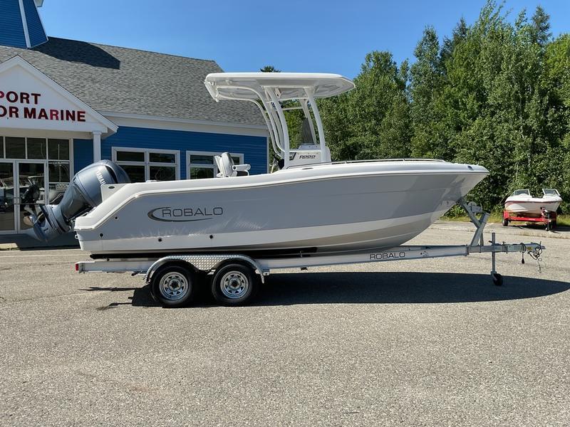 Robalo 222 EX 2025 Robalo 222 EX boat on trailer, parked outside marine store.