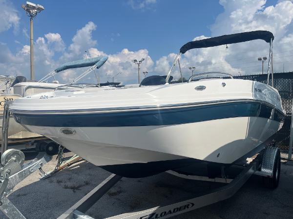Hurricane SunDeck Sport 192 RL OB 2021 Hurricane SunDeck Sport 192 RL OB boat on trailer, under a partly cloudy sky.