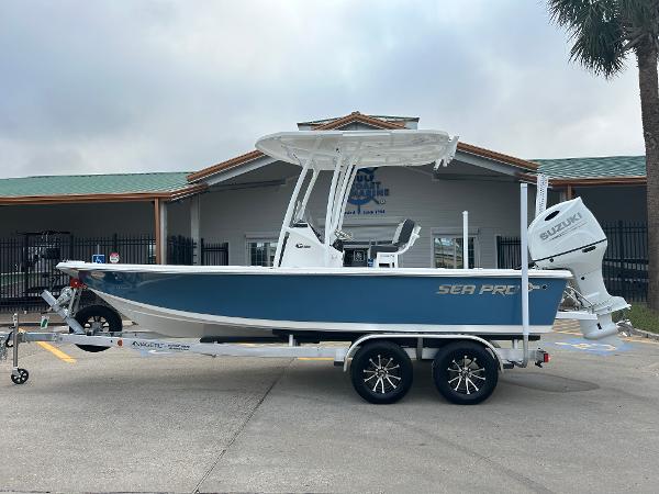 Sea Pro 210 Bay 2025 Sea Pro 210 Bay boat on trailer, blue hull, Suzuki outboard motor.