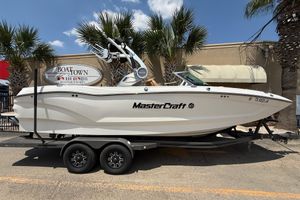 MasterCraft X24 2019 MasterCraft X24 boat on trailer, parked at Boat Town dealership.