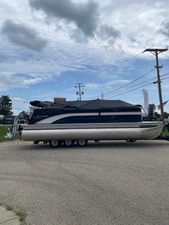 Lowe SS 230 WT Special 2026 Lowe SS 230 WT Special pontoon boat on trailer under cloudy sky.