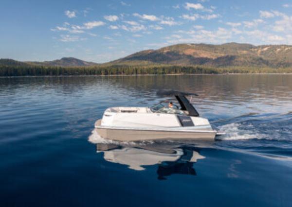 Ingenity EL Ingenity EL 2025 electric boat cruising on a serene lake with mountain backdrop.
