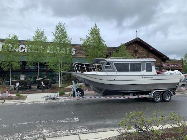 Spartan 2600 Olympia 2024 Spartan 2600 Olympia boat on trailer outside Bass Pro Shops.