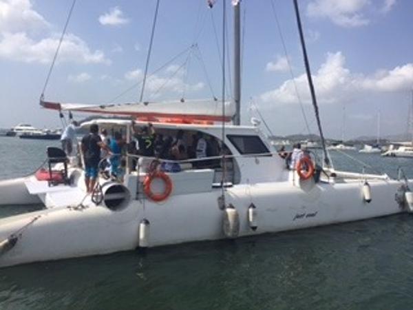 Custom Sunrise 59 Day Charter Custom Sunrise 59 Day Charter 2011 catamaran with passengers docked in a marina.