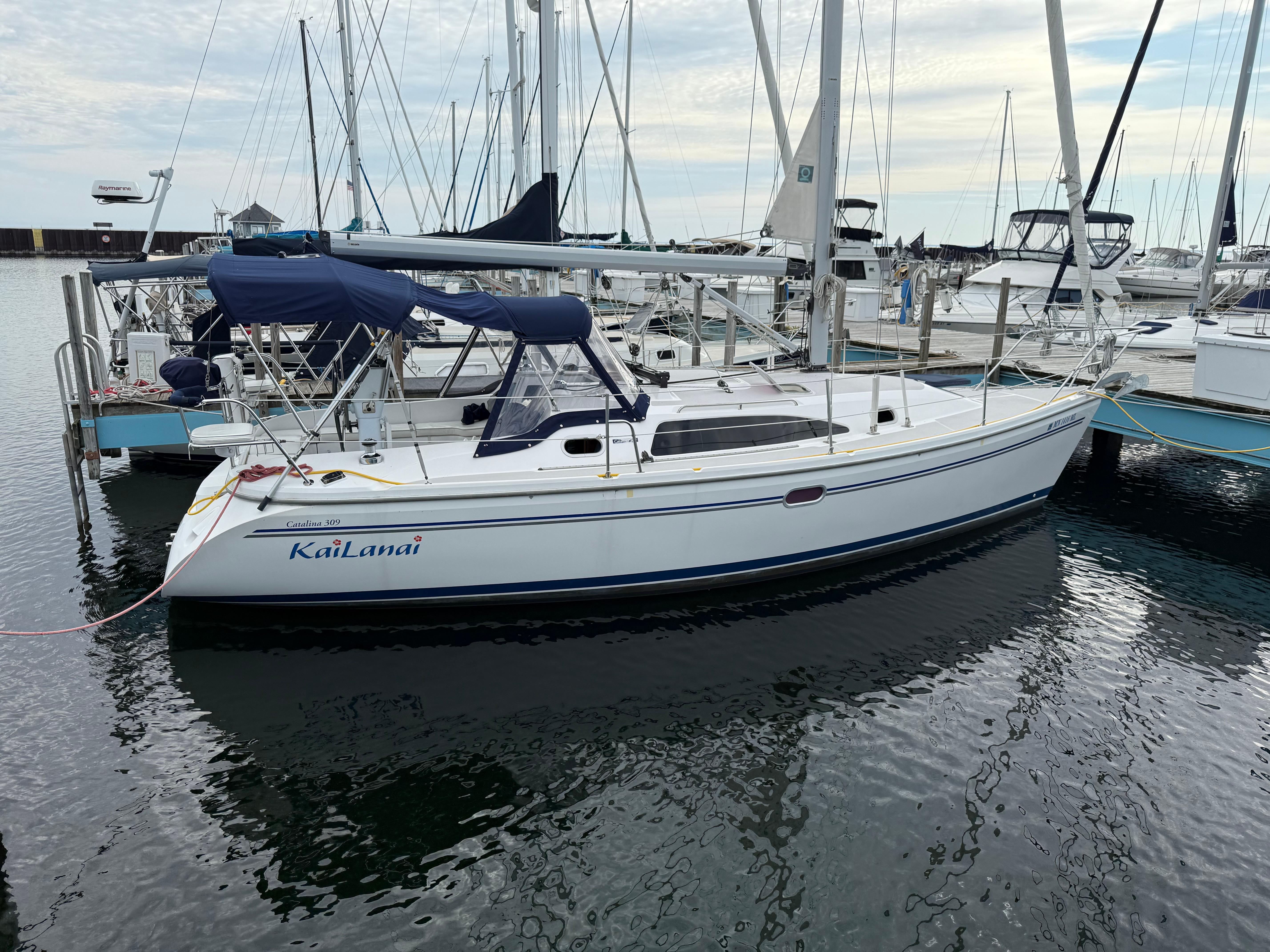 Catalina 309 Catalina 309 sailboat, 2007 model, docked in a marina with calm waters.