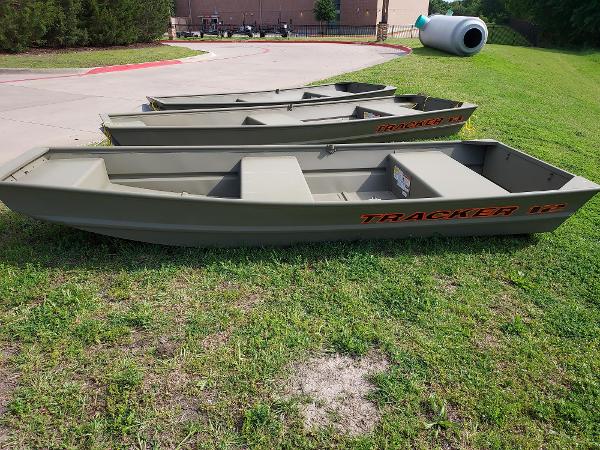 Tracker Grizzly 12 Jon Three 2025 Tracker Grizzly 12 Jon boats on grass, ready for outdoor adventures.