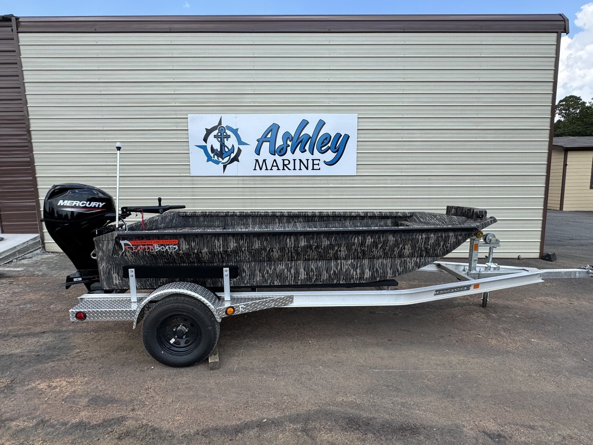 Reaper Boats 550 2026 Reaper Boats 550 on trailer at Ashley Marine, featuring Mercury outboard motor.