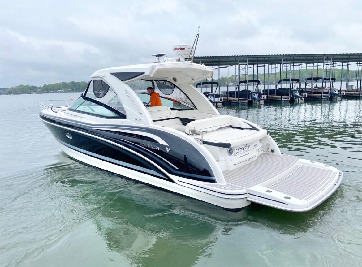 Formula 350 Sun Sport 2020 Formula 350 Sun Sport boat on calm water near a marina.