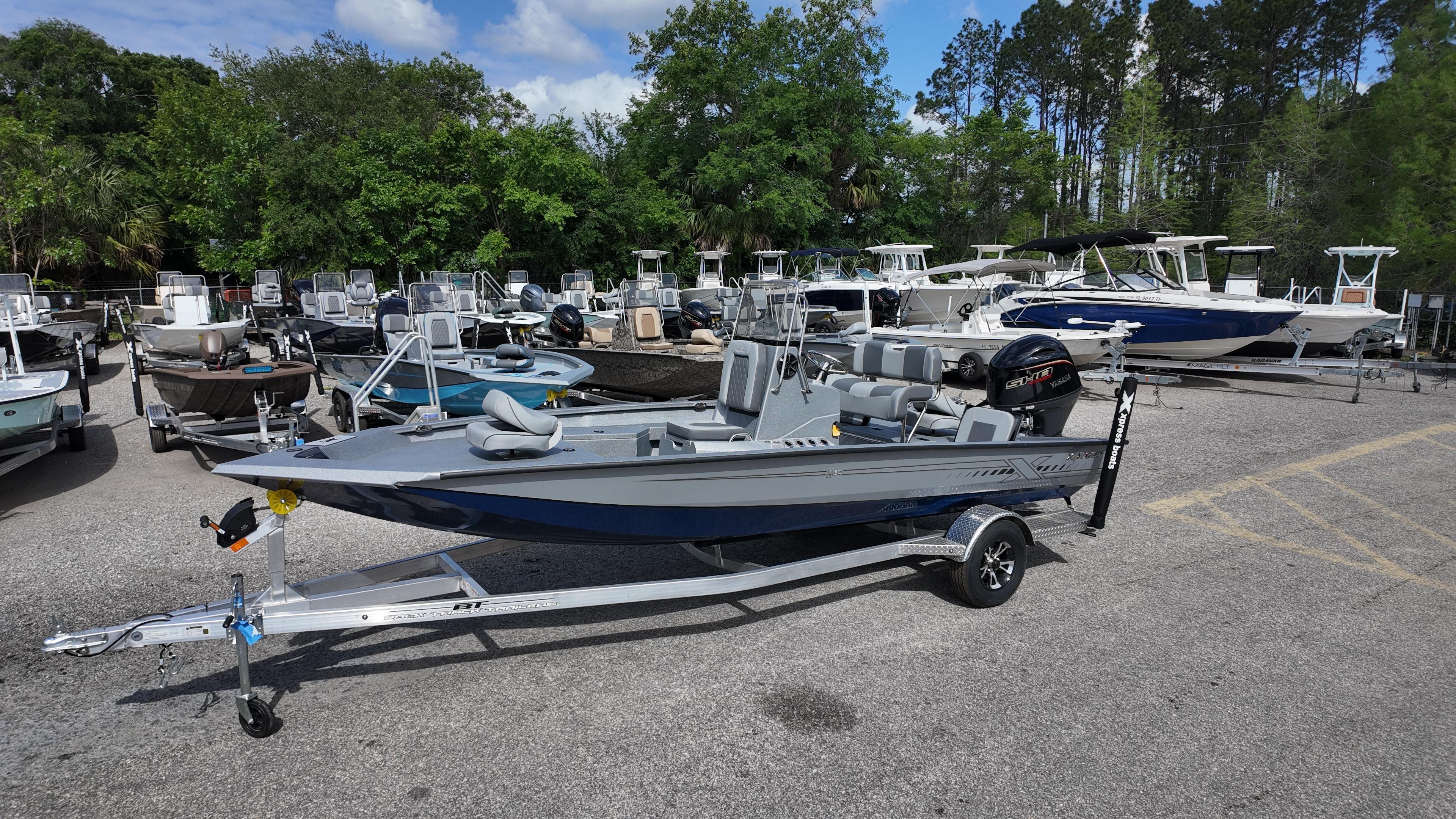 Xpress H20B 2026 Xpress H20B boat on trailer in outdoor showroom with other boats.
