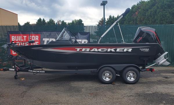 Tracker Targa V-19 WT 2025 Tracker Targa V-19 WT boat on trailer, black with red accents, parked outdoors.