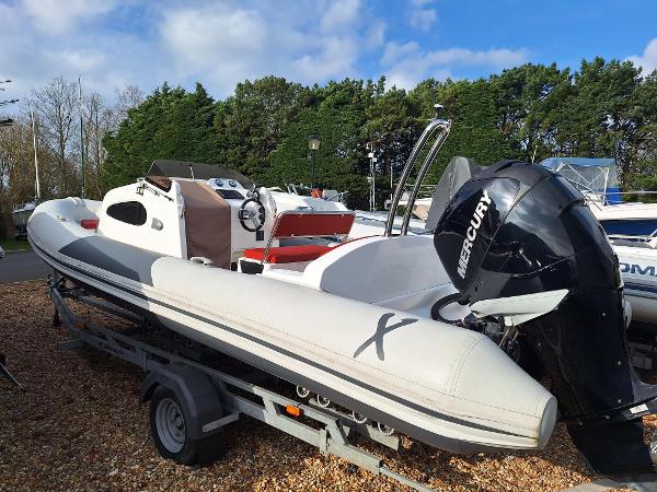 Rib-X Xp 740 Rib-X Xp 740 boat, 2020 model, on trailer with Mercury engine, parked outdoors.