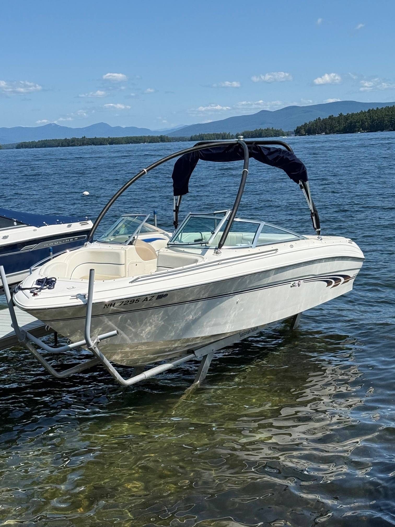 Sea Ray 210 Bow Rider 1997 Sea Ray 210 Bow Rider boat on a lake with scenic mountain backdrop.