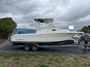 Robalo R235 Walkaround 2003 Robalo R235 Walkaround boat on trailer, parked outdoors under cloudy sky.