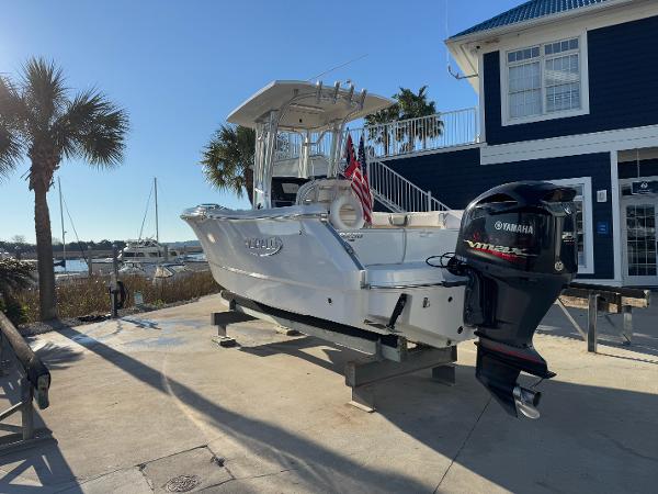 Robalo R230 Center Console 2021 Robalo R230 Center Console boat with Yamaha engine, docked near a marina.