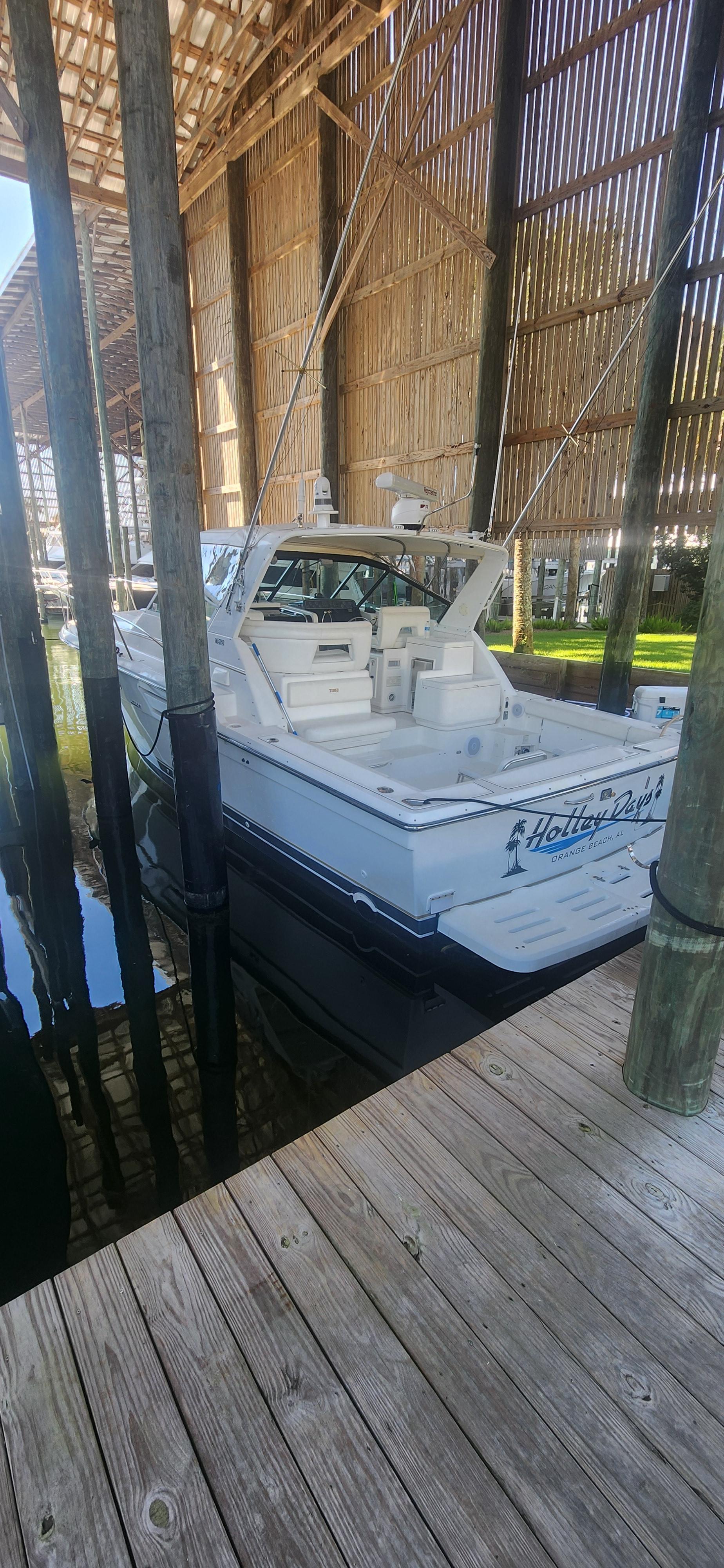 Tiara Yachts Open 2000 Tiara Yachts Open docked under wooden shelter, rear view.