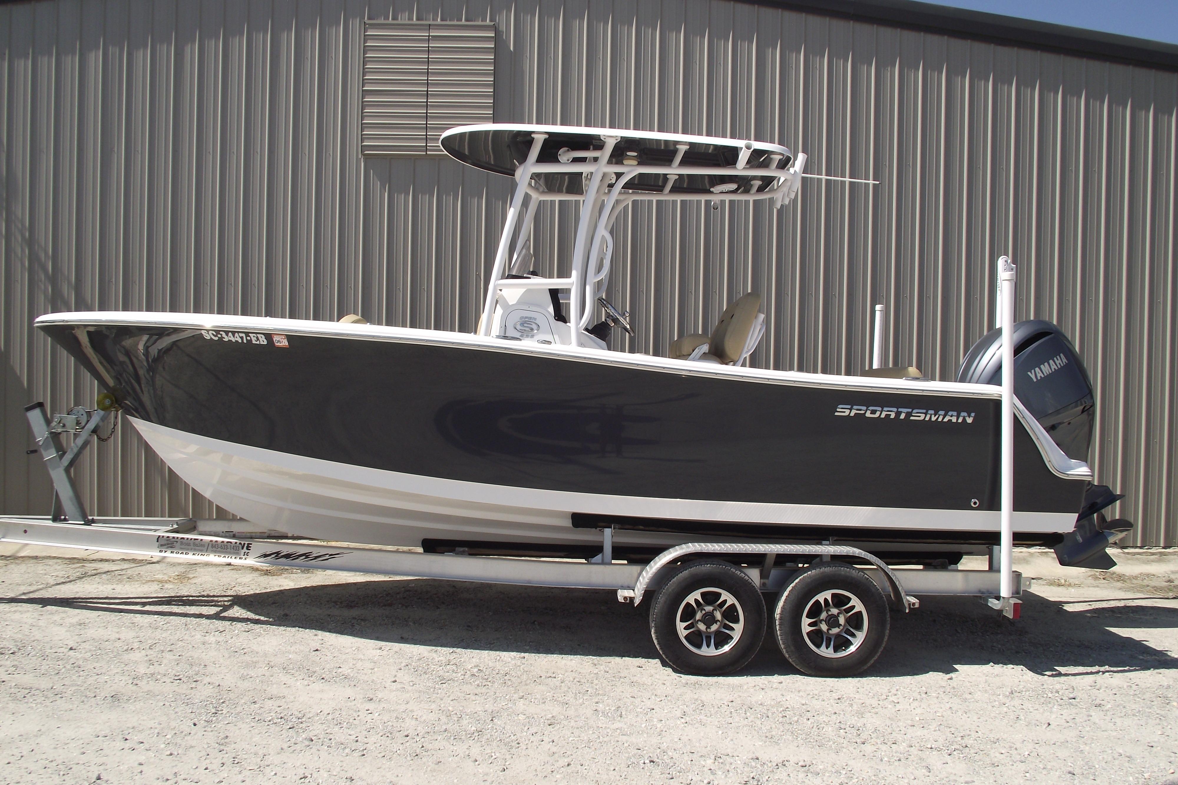 Sportsman Open 232 Center Console 2022 Sportsman Open 232 Center Console boat on trailer, parked outdoors.