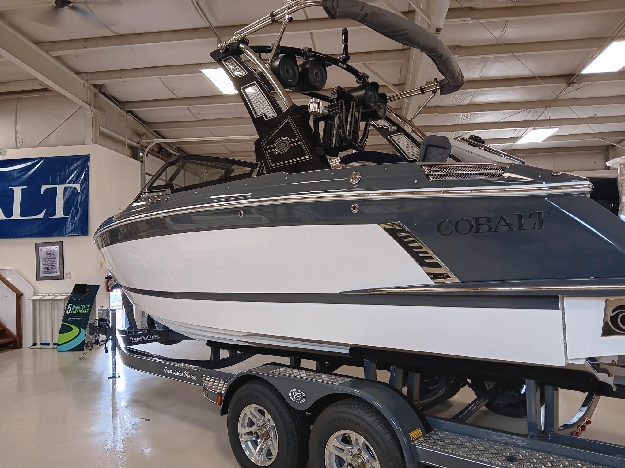 Cobalt R4 Surf 2026 Cobalt R4 Surf boat displayed indoors on a trailer.