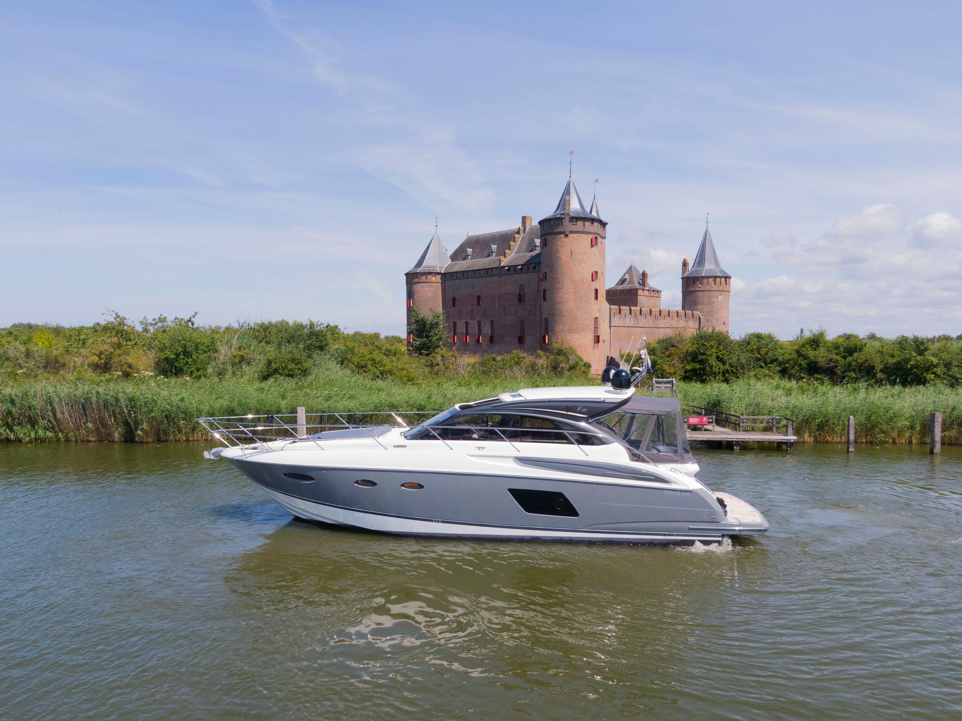 Princess V48 2014 Princess V48 yacht cruising near a historic castle on a sunny day.