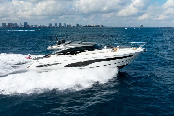 Princess V65 2019 Princess V65 yacht cruising on open water under a partly cloudy sky.