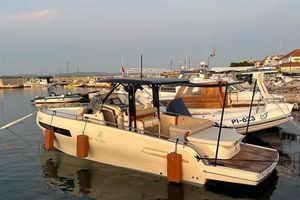 Invictus GT280 2023 Invictus GT280 boat docked at a marina during sunset.