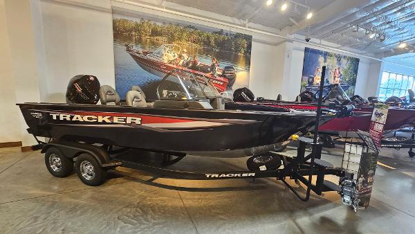 Tracker Targa V-19 WT 2025 Tracker Targa V-19 WT boat displayed in showroom with trailer.