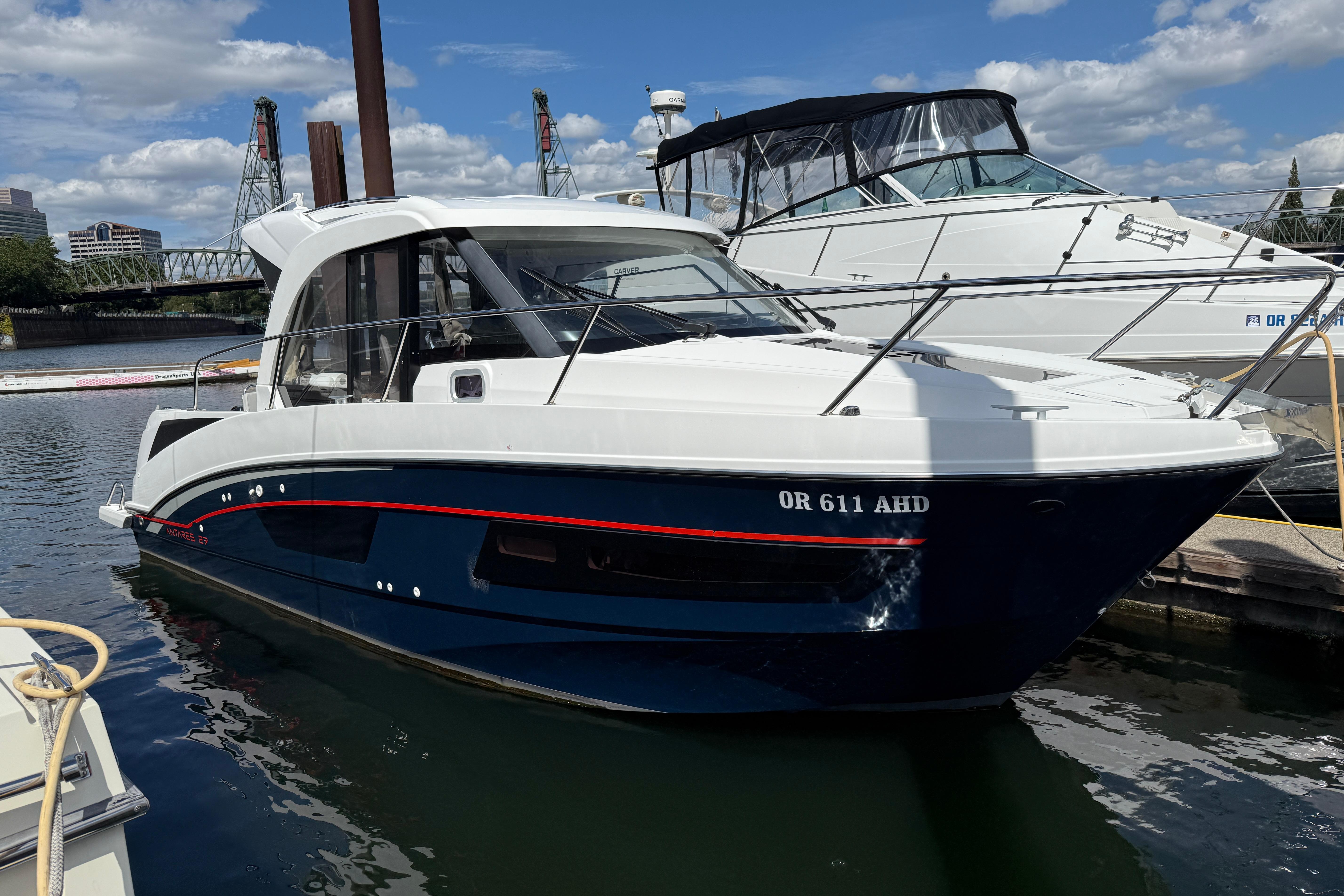 Beneteau Antares 9 2021 Beneteau Antares 9 boat docked in a marina under a blue sky.